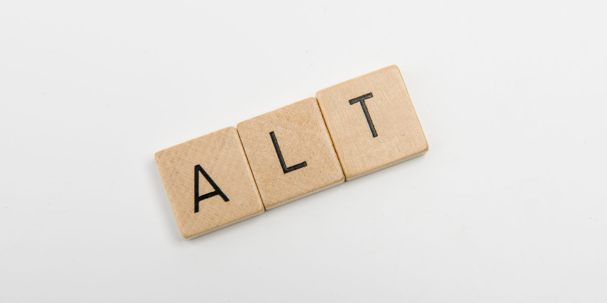 Three wooden, square pieces that spell out 'Alt'